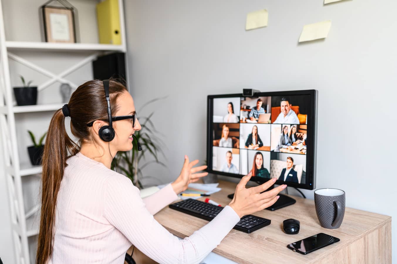 Woman with headset talks online with employees